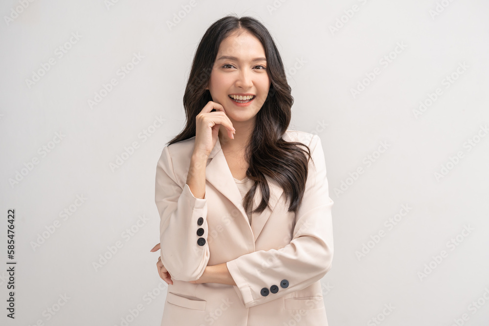 Smiling positive, attractive asian young woman, girl in beige suit formal dress, portrait elegant of pretty with long black hair, feeling happy looking at camera standing isolated on white background. Smiling positive, attractive asian young woman, girl in beige suit formal dress, portrait elegant of pretty with long black hair, feeling happy looking at camera standing isolated on white background.