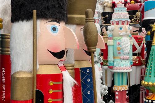 Giant nutcracker figurines in red soldiers' coats paraded for christmas