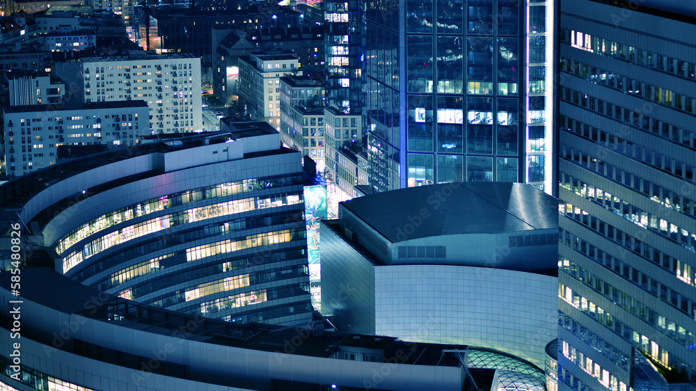 View of at night glass buildings and modern business skyscrapers,. View of modern skyscrapers and business buildings in downtown. Big city at night. View of at night glass buildings and modern business skyscrapers,. View of modern skyscrapers and business buildings in downtown. Big city at night.