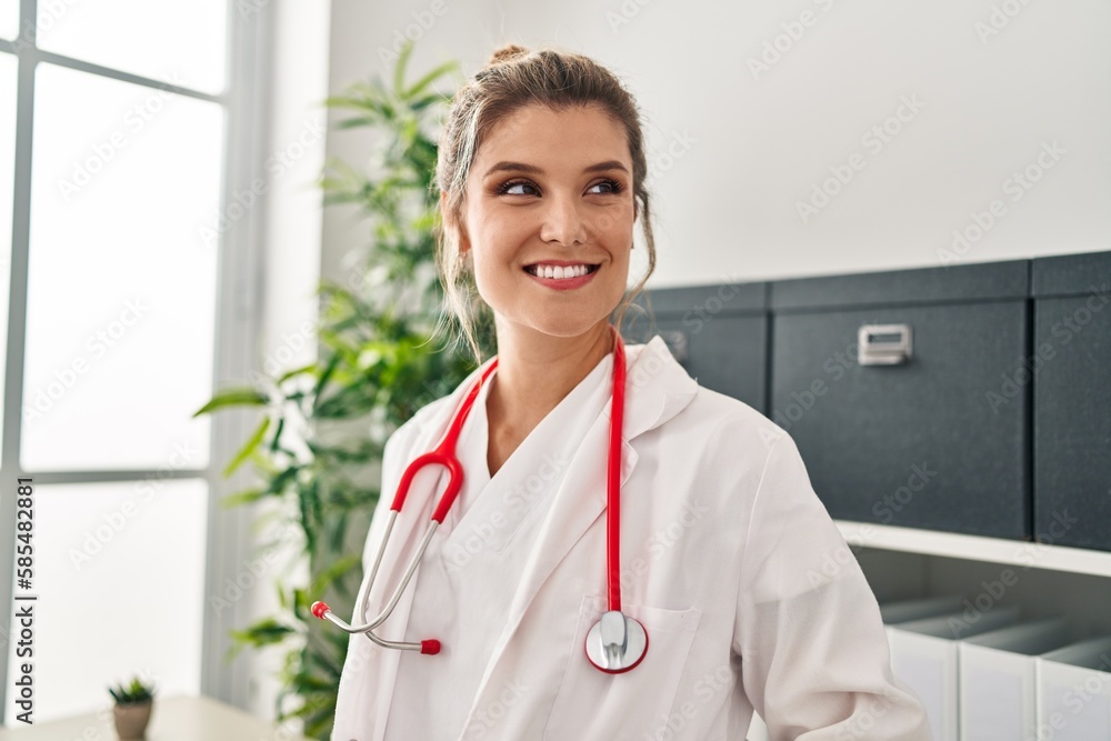 Young blonde woman wearing doctor uniform standing at clinic Young blonde woman wearing doctor uniform standing at clinic