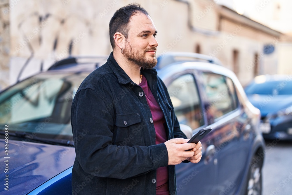Young hispanic man using smartphone leaning on car at street Young hispanic man using smartphone leaning on car at street