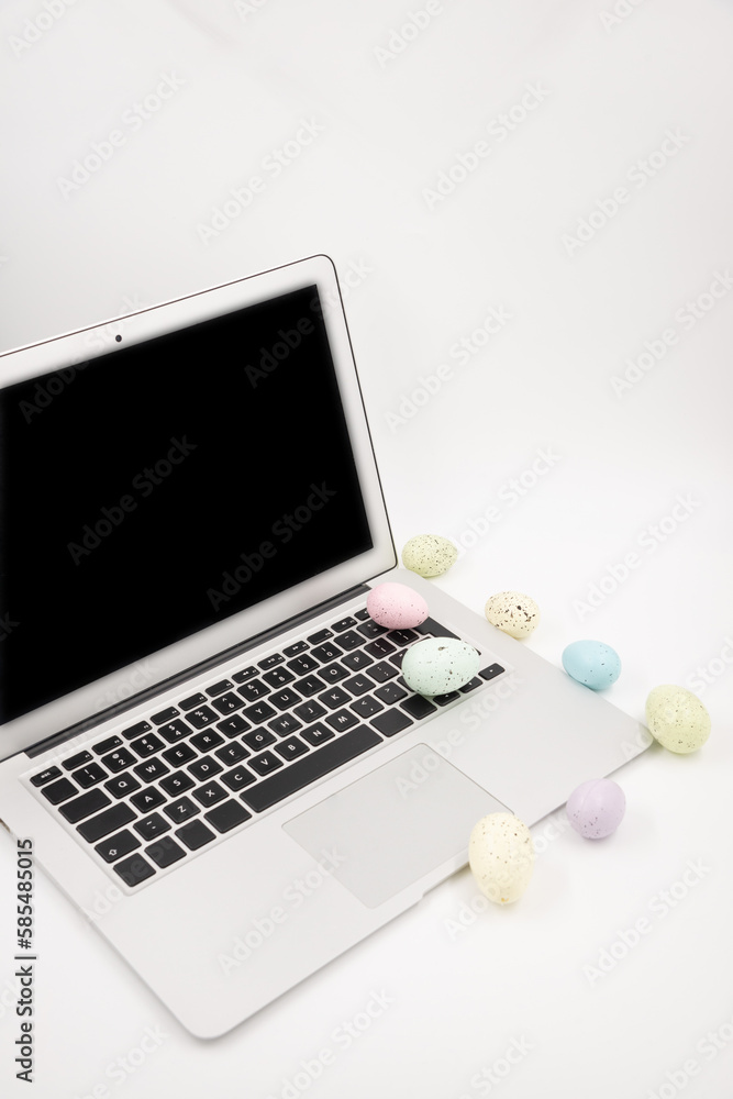 Computer with blank empty screen on white background of easter eggs. Space for text. Happy Easter! Computer with blank empty screen on white background of easter eggs. Space for text. Happy Easter!
