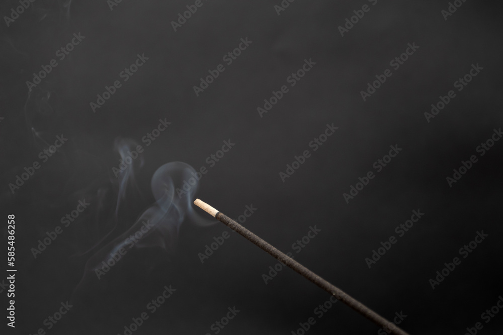 incense smoking stick on a black background incense smoking stick on a black background