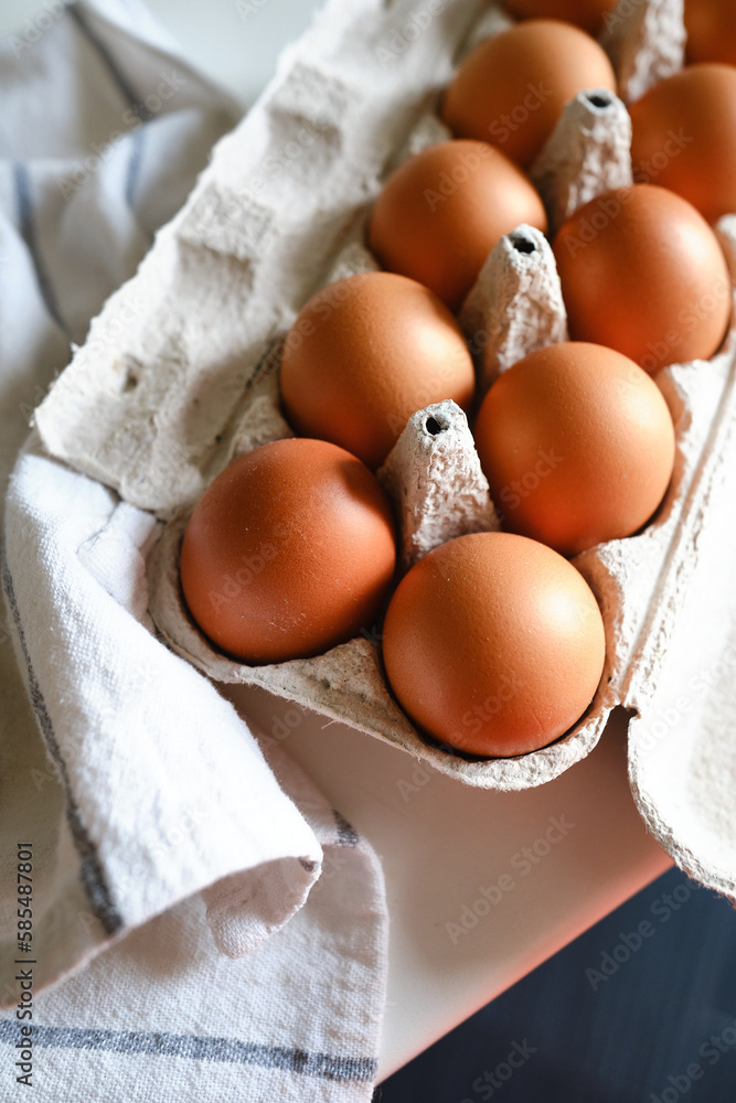 Cardboard boxes with chicken eggs. Boxes with uncooked eggs in table. Natural organic farm product. Preparing for Easter holiday. Fresh food delivery, carton package. Raw ingredient for cooking eat Cardboard boxes with chicken eggs. Boxes with uncooked eggs in table. Natural organic farm product. Preparing for Easter holiday. Fresh food delivery, carton package. Raw ingredient for cooking eat
