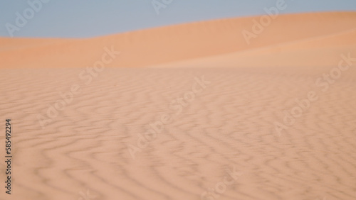 Sand dunes in the desert with a light on the top