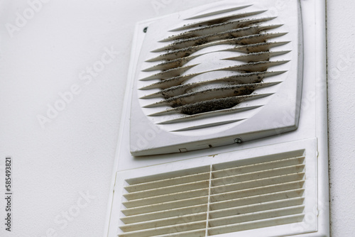 Fotografija Dirty grate of the ventilation duct in the bathroom, exhaust hood clogged with d