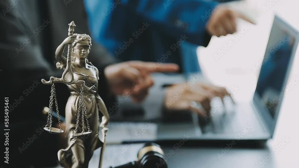 Business and lawyers discussing contract papers with brass scale on desk in office. Law, legal services, advice, justice and law concept picture with film grain effect Business and lawyers discussing contract papers with brass scale on desk in office. Law, legal services, advice, justice and law concept picture with film grain effect