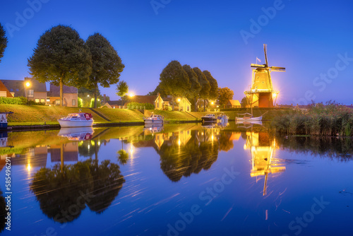 Dokkum, Netherlands. The famous windmill. Journey through the Netherlands. Historical sites and famous places. Dutch canals with boats.
