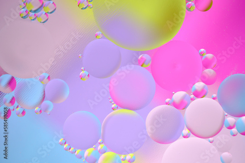 Abstract bright background, oil circles on the water surface.