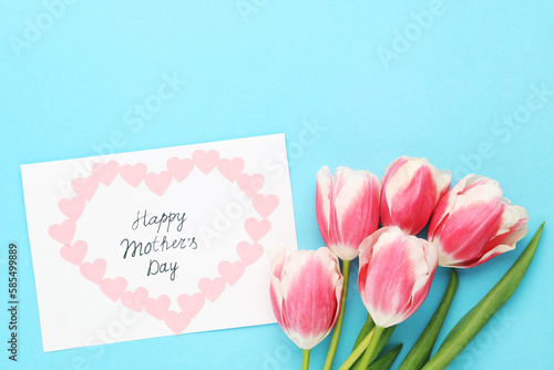 Text Happy Mother's Day with tulip flowers on blue background