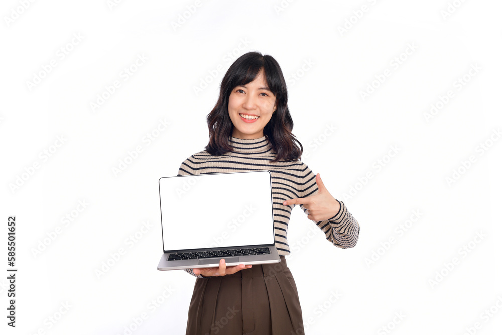 Beautiful young Asian woman on sweater cloth pointing index finger on laptop pc computer and looking at camera with smile face and happy isolated on white background
