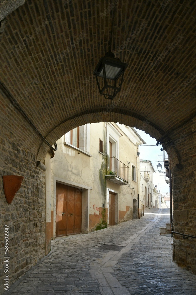 A narrow street among the old houses of Pietramontecorvino, a medieval village in the state of Puglia in Italy.