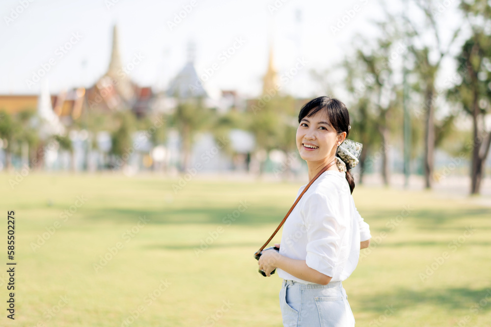 Portrait beautiful young asian woman on summer holiday vacation trip with the grand palace in a background at Bangkok, Thailand Portrait beautiful young asian woman on summer holiday vacation trip with the grand palace in a background at Bangkok, Thailand
