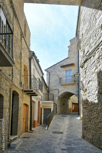 Fototapeta Naklejka Na Ścianę i Meble -  A narrow street among the old houses of Pietramontecorvino, a medieval village in the state of Puglia in Italy.