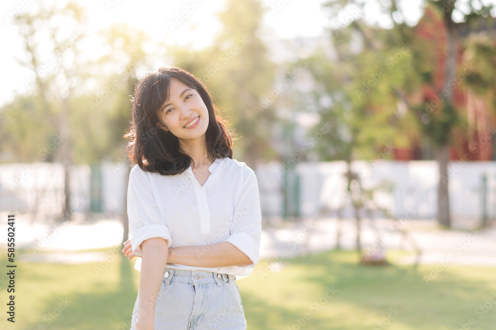 Portrait young beautiful asian woman with happy smile around outdoor park in sunny summer day Portrait young beautiful asian woman with happy smile around outdoor park in sunny summer day