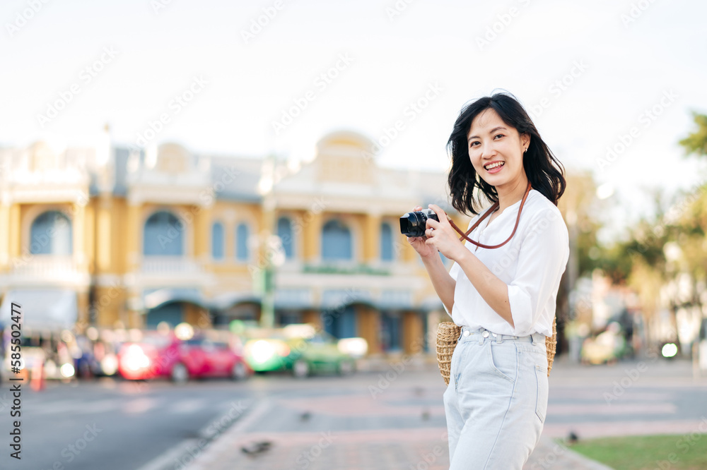 Portrait beautiful asian woman traveler with camera explore street on summer vacation in Bangkok, Thailand
