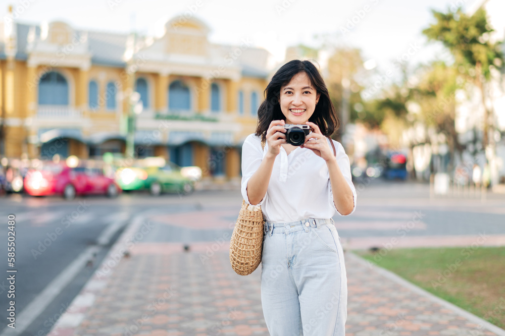 Portrait beautiful asian woman traveler with camera explore street on summer vacation in Bangkok, Thailand Portrait beautiful asian woman traveler with camera explore street on summer vacation in Bangkok, Thailand