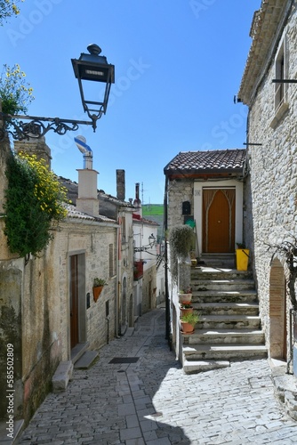 A narrow street among the old houses of Pietramontecorvino, a medieval village in the state of Puglia in Italy. photo