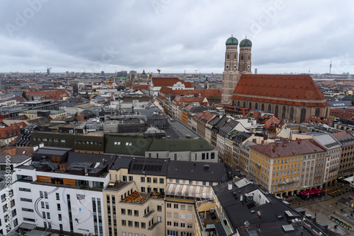 View from the bell tower of the church of saint Peter of the city of Munich, where you can see the cathedral and the town hall, on a cloudy and rainy day.