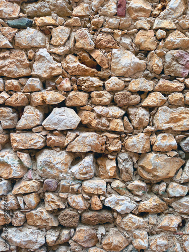 Background of old wall of stone and mud. Rustic stone facade. Constructions and Architecture.