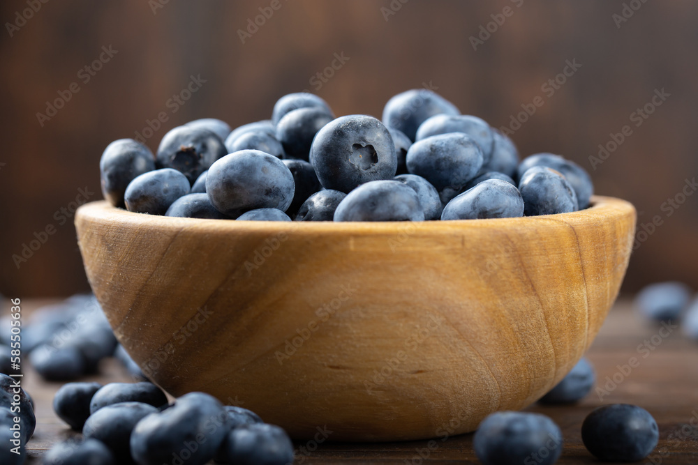 Fresh blueberry in wooden bowl. Concept of healthy and dieting eating. Fresh blueberry in wooden bowl. Concept of healthy and dieting eating.
