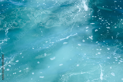 Natural background of blue foaming sea water