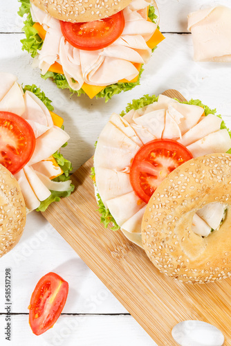 Bagel sandwich with chicken ham for breakfast from above portrait format