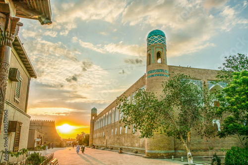Sunset in old   town of   old Khiva   and blue-green heads of Minarets photo