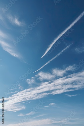 Blue sky with clouds and plane trails Generative AI