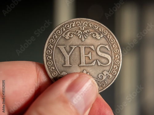 A real decision-making coin held in hand