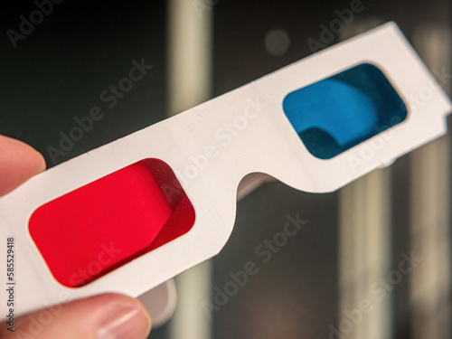 A 3D glasses with red/blue foil in hand photo