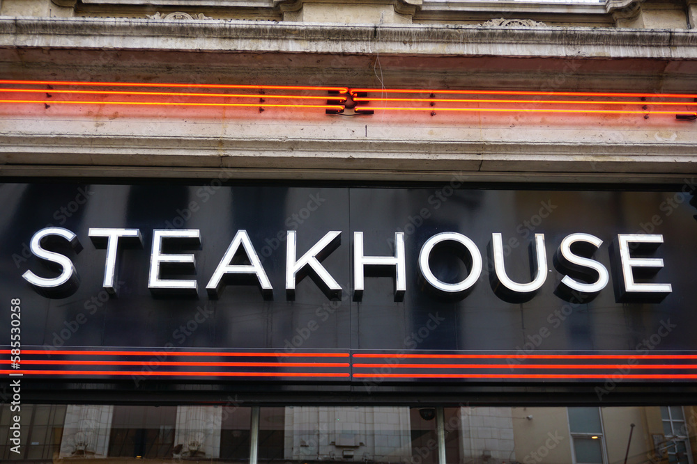 steakhouse sign on exterior of restaurant. Food eatery in city 