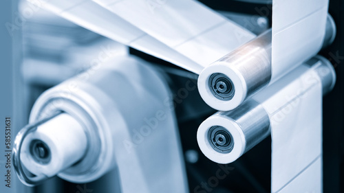 Fragment of the conveyor of sticking labeling machine. Abstract industrial background.