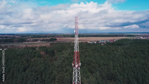 Cell tower aerial view. Drone flying near the broadcast tower. Cellular 5g 4g 3g