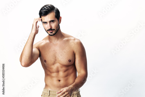 Male athlete model with naked torso and packs of abs sporty on white isolated background, trendy clothing style, copy space, space for text
