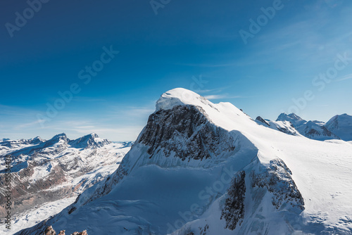 Ski slope and snow covered winter mountains. Matterhorn is a mountain in the Pennine Alps on the border between Switzerland and Italy. Peak of the Matterhorn Glacier Paradise.