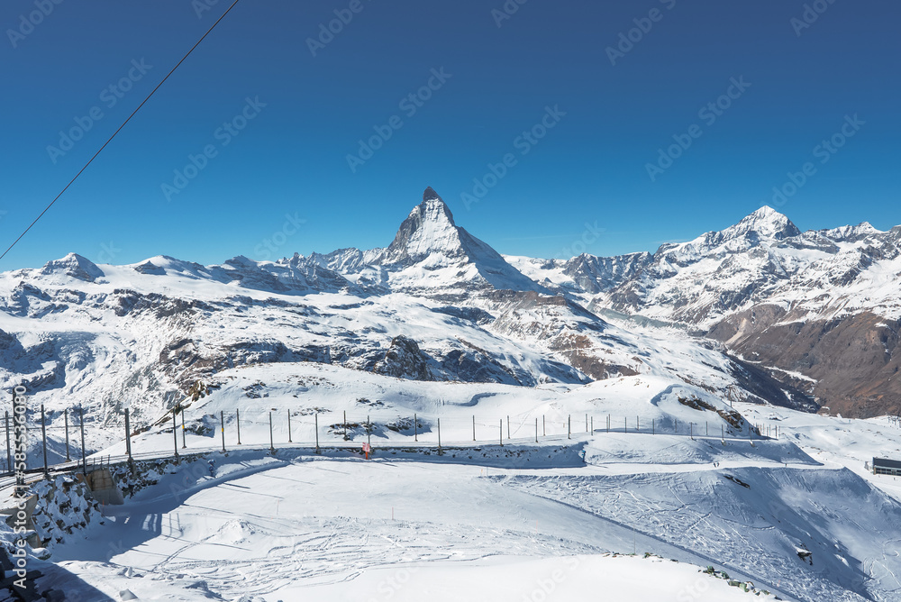 Matterhorn peak in Zermatt with a beautiful ski slopes all around it. Ski resort in Switzerland.