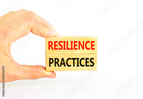 Resilience practices symbol. Concept word Resilience practices typed wooden blocks. Beautiful white table white background. Businessman hand. Business and resilience practices concept. Copy space.