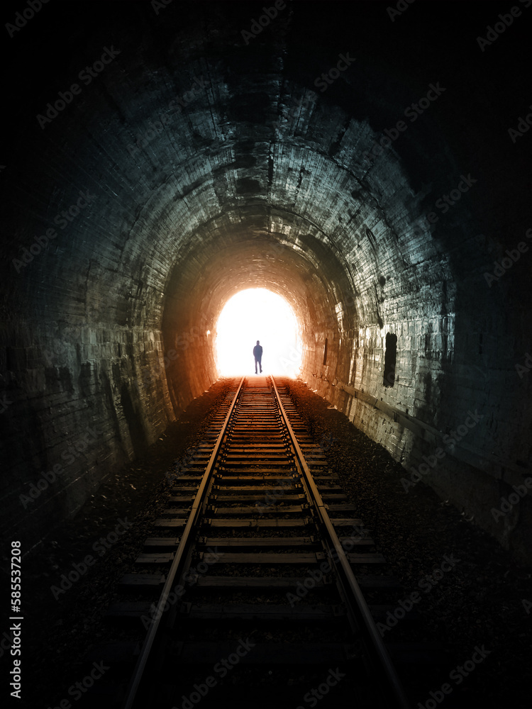 Life after death. Man walking to the end of a tunnel. Metaphor fantasy illustration symbolizes the end of the life and passage to other side.