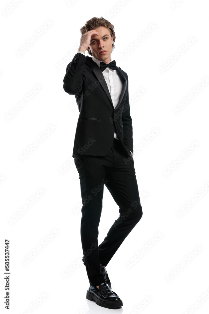 businessman folding one leg and touching forehead