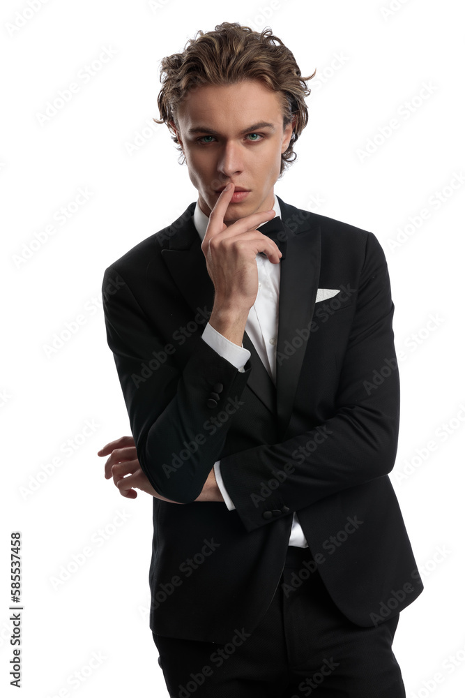 businessman touching his lip with a sensual and tough attitude businessman touching his lip with a sensual and tough attitude