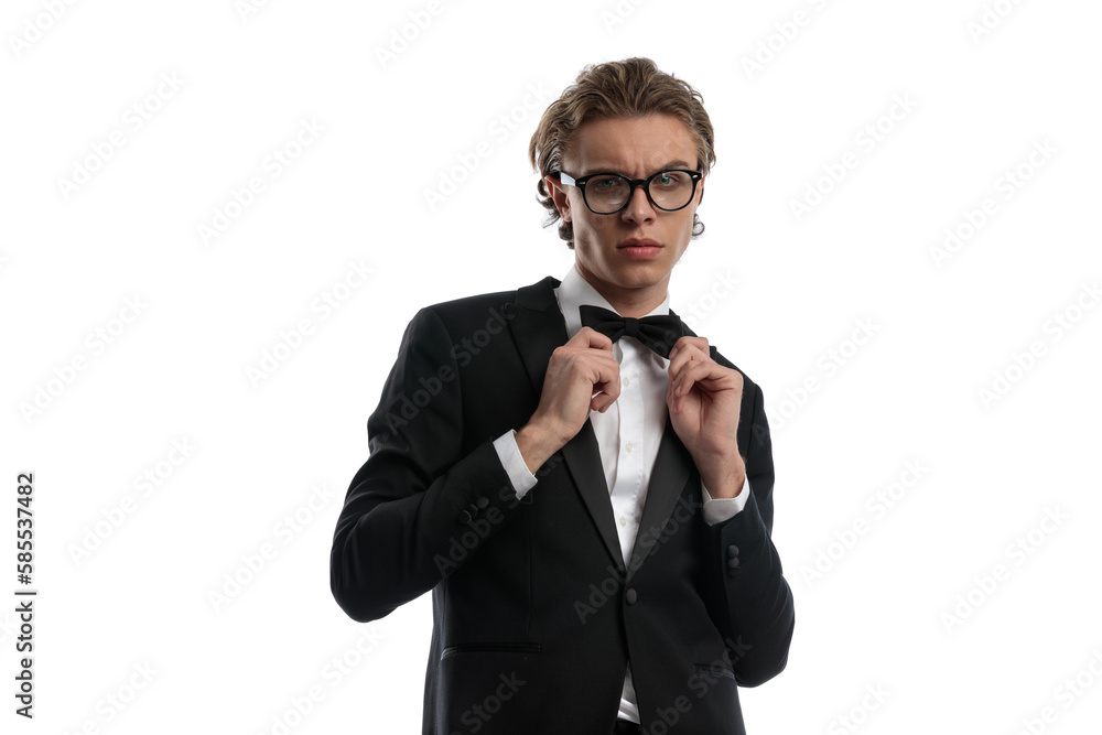 businessman fixing his bowtie and wearing eyeglasses businessman fixing his bowtie and wearing eyeglasses