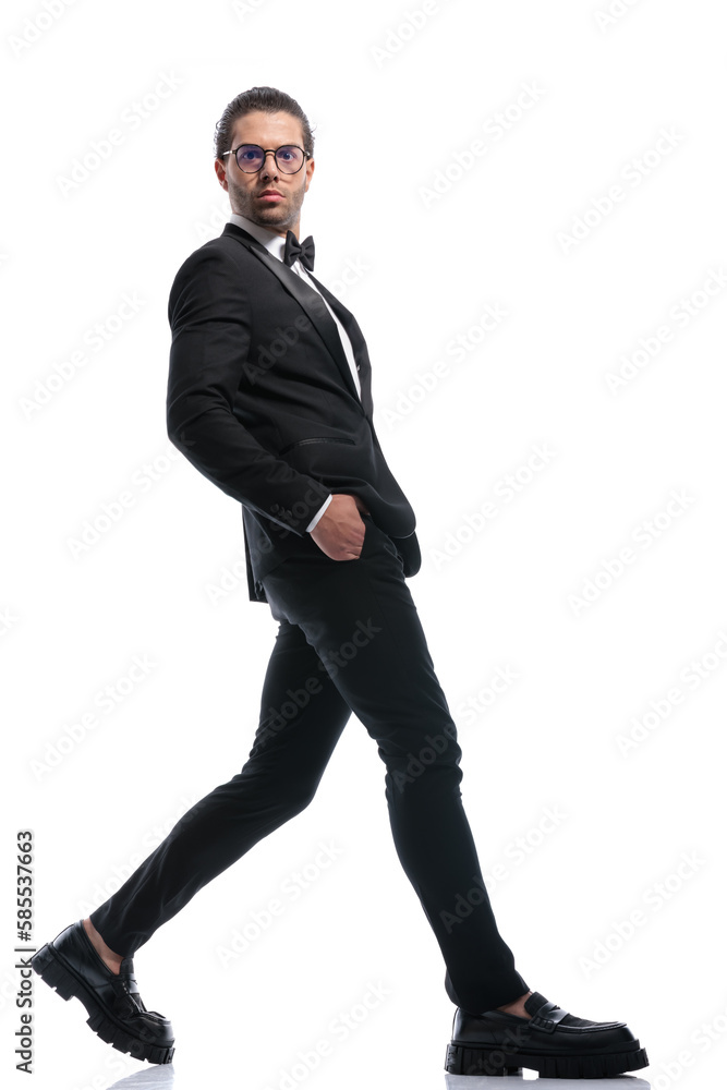 businessman stepping wide with hands in pockets