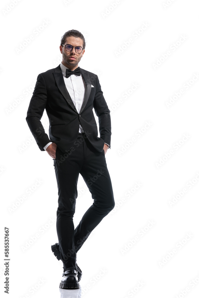 businessman crossing legs and putting hands in pockets businessman crossing legs and putting hands in pockets