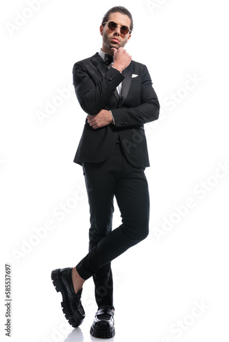 businessman touching chin and crossing legs