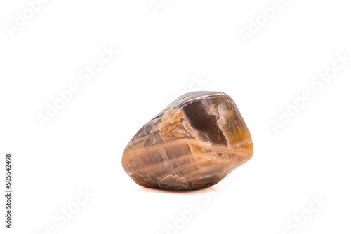 Macro tumbled dark peach moonstone crystal, aluminium silicate mineral, brown and peach gem isolated on a white background surface photo