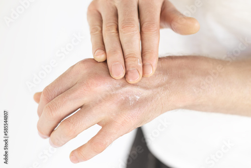 Fototapeta Naklejka Na Ścianę i Meble -  a man applies a cosmetic cream on his hands. male skin care concept