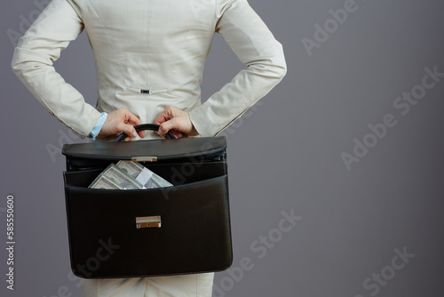 Seen from behind female worker in light business suit