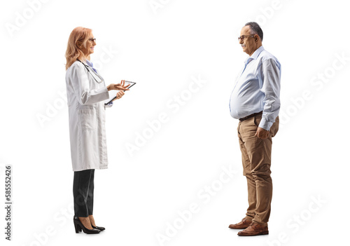 Full length profile shot of a mature male patient listening to a female physician