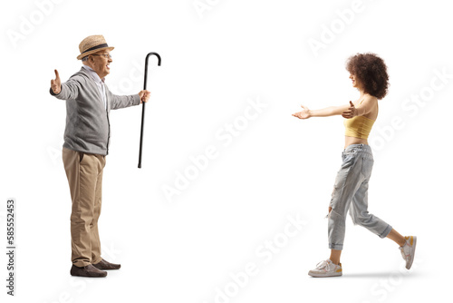 Young woman walking towards a senior man with arms wide open